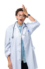 Young african american doctor woman wearing medical coat over isolated background surprised with hand on head for mistake, remember error. Forgot, bad memory concept.