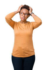 Fototapeta premium Young beautiful african american woman wearing glasses over isolated background confuse and wonder about question. Uncertain with doubt, thinking with hand on head. Pensive concept.