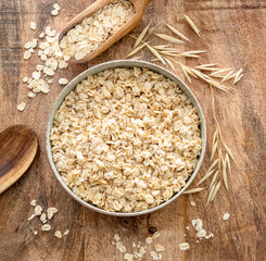 Bowl of porridge or oatmeal on wooden table. Top view.