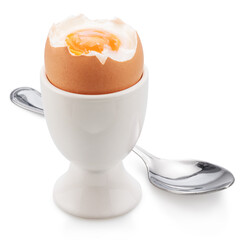 Brown soft-boiled cracked chicken egg in the egg cups isolated on white background.