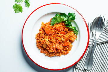 Ptitim with chicken, vegetables and cilantro, white background. Traditional Israeli food.