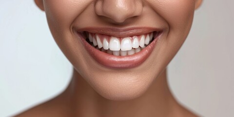 A close-up shot capturing the beautiful smile of a woman with white, healthy teeth. Perfect for dental care promotions or advertisements