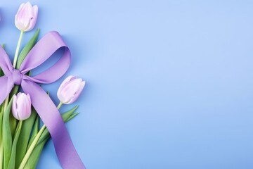 purple ribbon and tulip flower on blue background with copy space for text. Healthcare and medical concept.