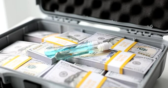 Test tubes with blue liquid vaccine or poison in suitcase with dollars. Selling illegal toxic substance drugs