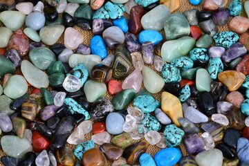 Different colorful 
semi-precious stones in a box.