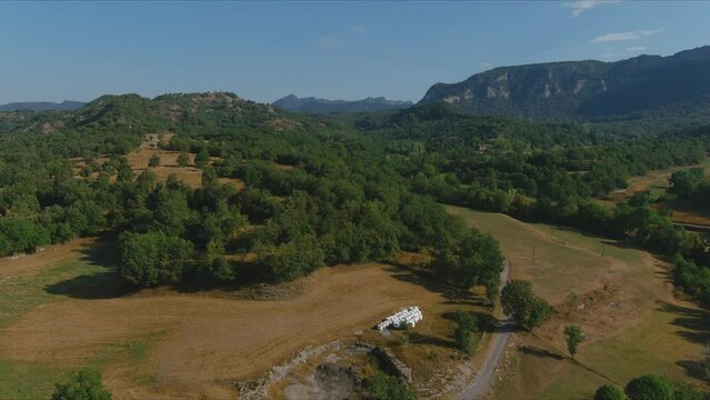 Drone zoom out to discover concrete road at Esquirol village, Barcelona