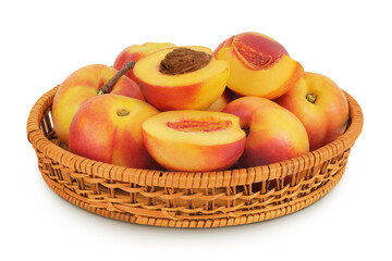 Ripe nectarine fruit with half in a wicker basket isolated on white background with full depth of field