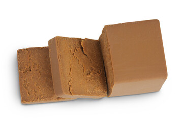 Brown cheese. Norwegian brunost isolated on white background. Top view. Flat lay