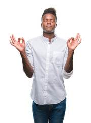 Young african american man over isolated background relax and smiling with eyes closed doing meditation gesture with fingers. Yoga concept.