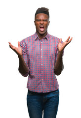 Fototapeta premium Young african american man over isolated background crazy and mad shouting and yelling with aggressive expression and arms raised. Frustration concept.