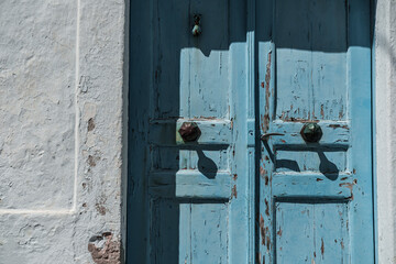 old blue painted wooden doors, entrance, whitewashed wall, mediterranean greek house