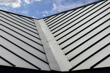 Standig seam metal roofing system on sky background