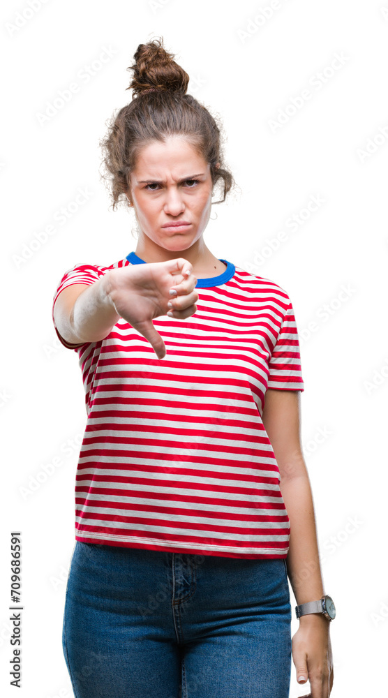 Sticker Beautiful brunette curly hair young girl wearing casual look over isolated background looking unhappy and angry showing rejection and negative with thumbs down gesture. Bad expression.