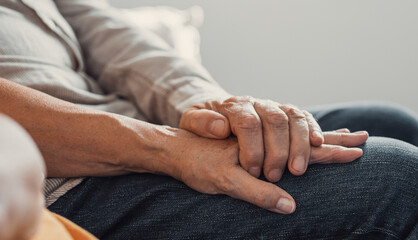 Close up elderly affectionate woman covering wrinkled hands of mature husband, showing love and...