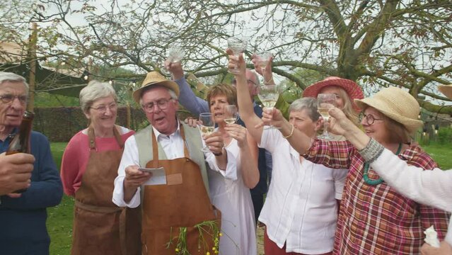group of seniors friends people singing and cheering at outdoors party