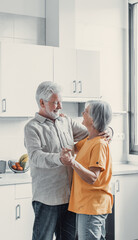 Joyful active old retired romantic couple dancing laughing in living room, happy middle aged wife and elder husband having fun at home, smiling senior family grandparents relaxing bonding together. - obrazy, fototapety, plakaty
