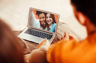 Portrait of smiling couple with laptop on sofa at home