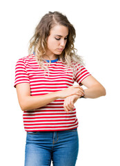 Beautiful young blonde woman over isolated background Checking the time on wrist watch, relaxed and confident