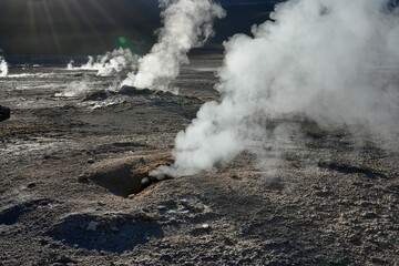 Fototapeta na wymiar Steam rising from the ground at The Geysers Del Tatio, Antofagasta, Chile.