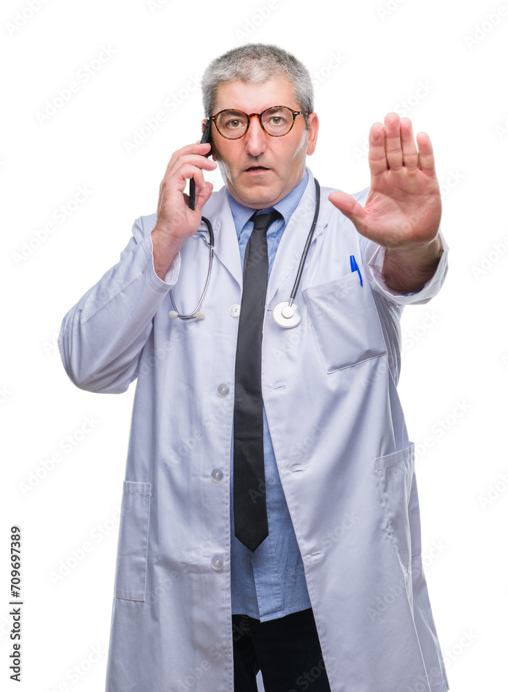 Canvas Prints Handsome senior doctor man talking on smarpthone over isolated background with open hand doing stop sign with serious and confident expression, defense gesture