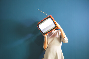 surreal woman covers her face with a television without connection, abstract concept