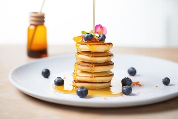 mini pancakes stack with a syrup drizzle - obrazy, fototapety, plakaty