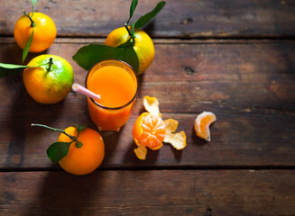 Glass of fresh tangerine juice with ripe tangerines