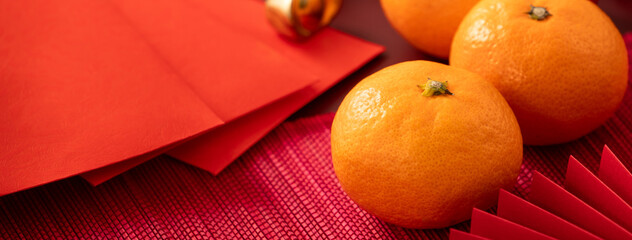 Chinese lunar new year background with fresh tangerine and red envelope.
