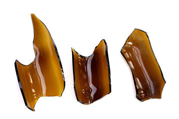 Broken brown bottle, glass shards on white background
