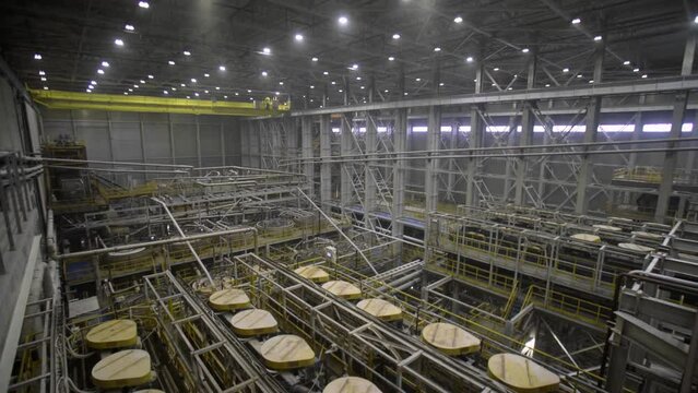 The ore is transported at the plant. An industrial conveyor at an ore processing plant.