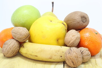 Healthy diet concept. Fruits and nuts on wooden table.