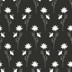 Monochrome eamless pattern with black wild flowers silhouettes on white background. Vintage ditsy floral repeat pattern.