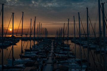sailboats are waiting at sunrise in the morning