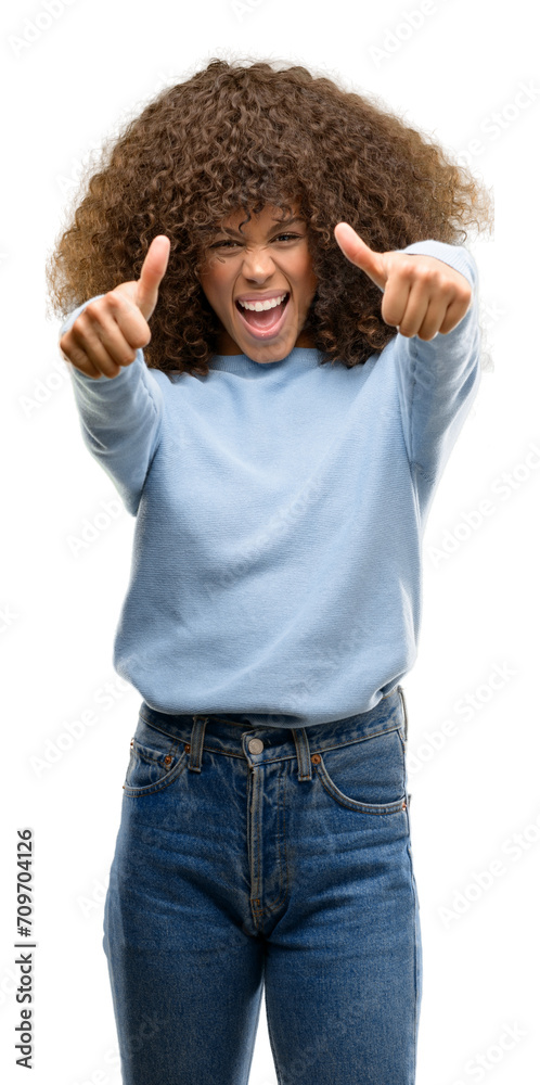 Sticker african american woman wearing a sweater approving doing positive gesture with hand, thumbs up smili