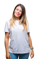Obraz premium Young beautiful woman casual white t-shirt over isolated background winking looking at the camera with sexy expression, cheerful and happy face.