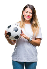 Young beautiful woman holding soccer ball over isolated background with a happy face standing and smiling with a confident smile showing teeth