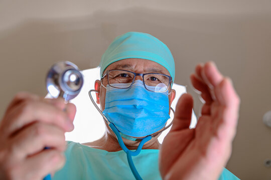 Close-Up 4K Ultra HD Image of Asian Doctor Checking Patient - Medical Care Concept