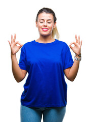 Young beautiful woman wearing casual blue t-shirt over isolated background relax and smiling with eyes closed doing meditation gesture with fingers. Yoga concept.