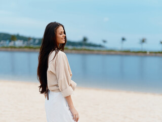 Beautiful Summer Portrait: Stylish Caucasian Woman Relaxing on a Beach Chair, gazing at the Ocean,...