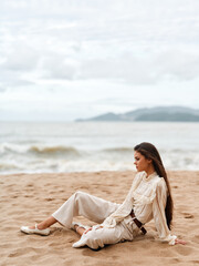 Beauty in Nature: A Stylish, Elegant Lady Sitting Alone on a Beach Chair, Enjoying the Sunset...