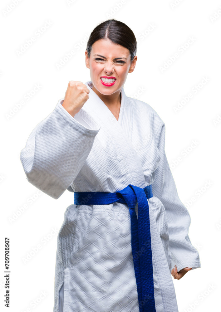 Canvas Prints young beautiful woman wearing karate kimono uniform over isolated background angry and mad raising f