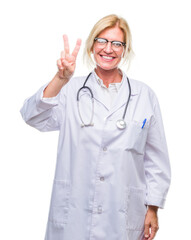 Middle age blonde doctor woman over isolated background showing and pointing up with fingers number two while smiling confident and happy.