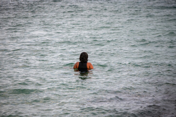 Rear view of woman seen swimming