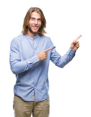 Young handsome man with long hair over isolated background smiling and looking at the camera...