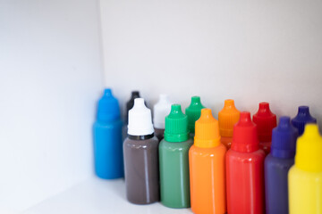 Bottles of art paints of various colors were lined up in large numbers