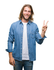 Young handsome man with long hair over isolated background smiling with happy face winking at the...