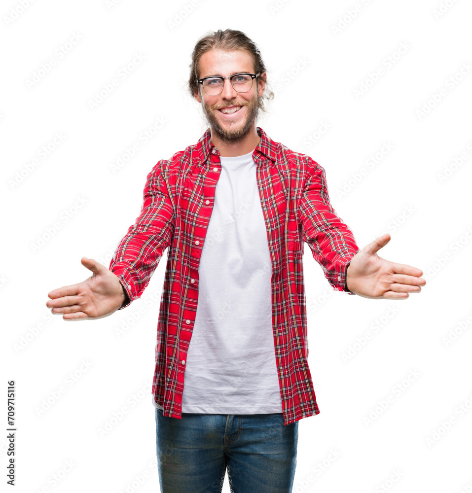 Sticker Young handsome man with long hair wearing glasses over isolated background looking at the camera smiling with open arms for hug. Cheerful expression embracing happiness.