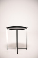 Stylish coffee table in loft style on a white background. Metal black round coffee table isolated on a white background.