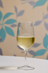 a glass of white wine on a table in the kitchen