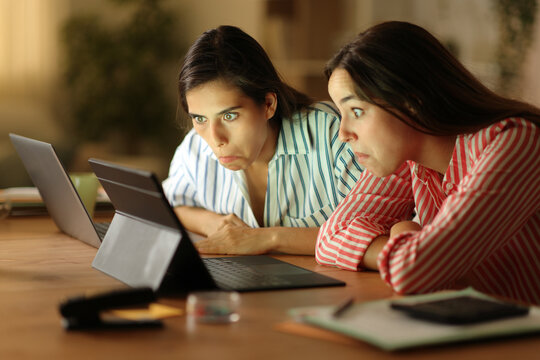 Perplexed tele workers watching media in the night
